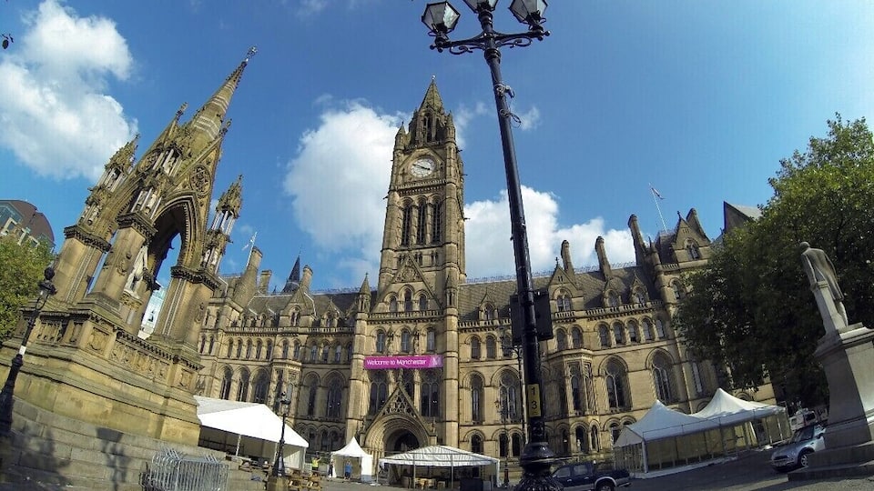 A historic building with a prominent clock tower and intricate architecture.