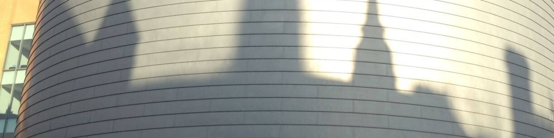 The University of Manchester building with a curved facade and the name inscribed on it.