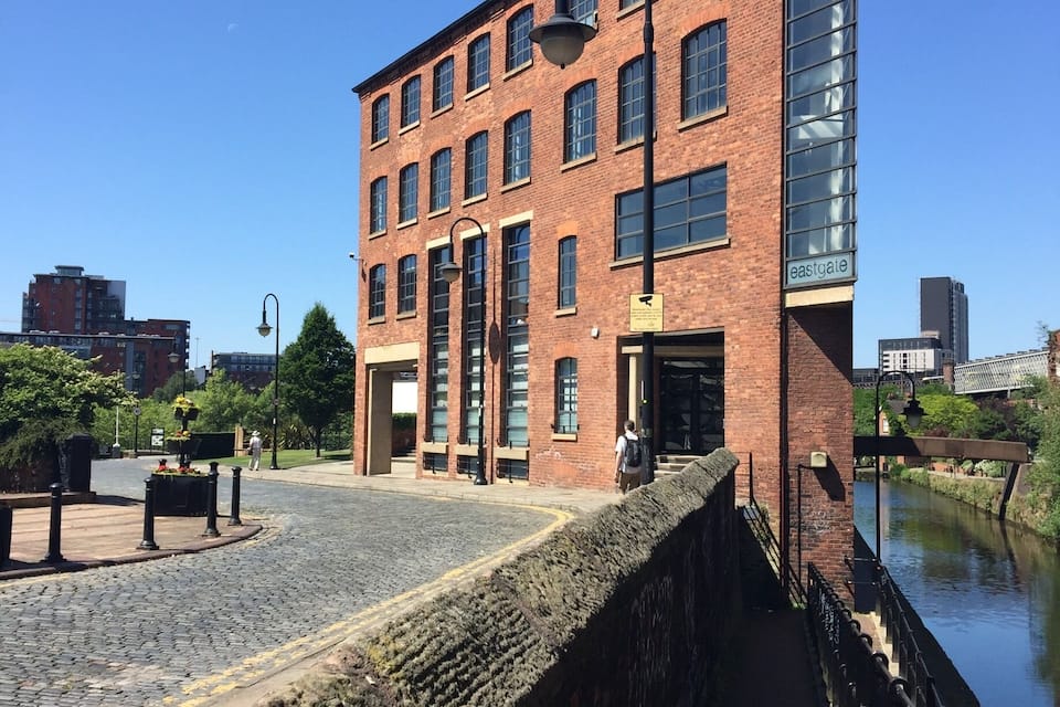 A brick building with large windows and a sign reading "eastgate".