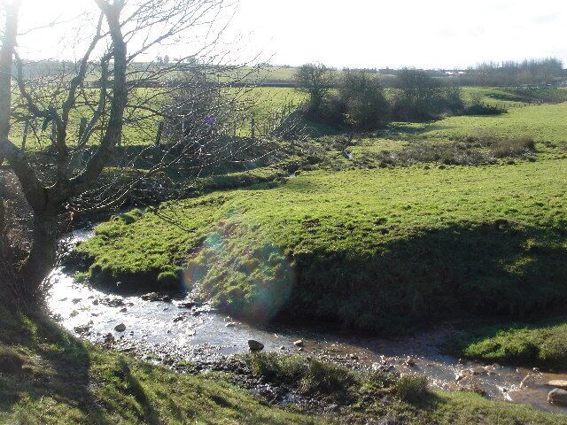 Old Mill Brook near Tyldesley. A meandering brook in fields near Tyldesley. The fields used to be dotted with farms and colliery workings. Only the farms remain.