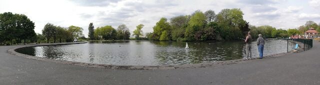 Platt Fields Park. A panoramic view of Platt Fields Park lake. The heart-shaped lake and island were constructed in the winter of 1908-9 by some 700 previously unemployed men.