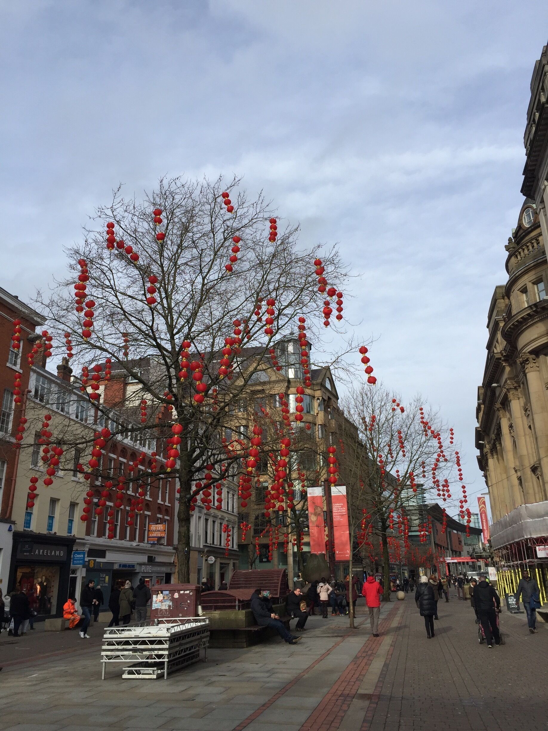 A street lined with red lanterns and buildings.