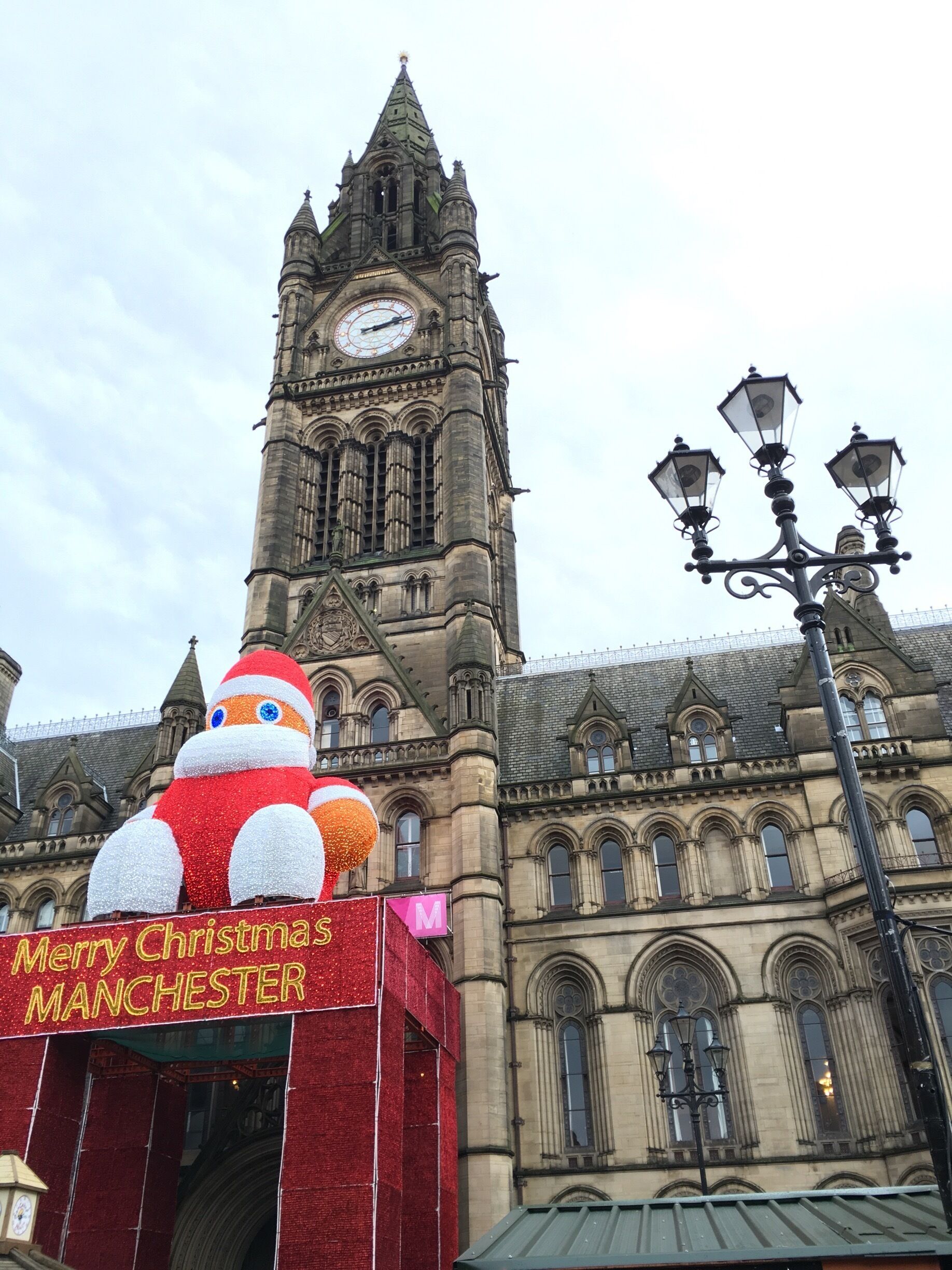The magnificent clock tower of Manchester Town Hall reaches for the winter sky, while a festive-looking Zippy spreads some festive cheer over the fantastic Christmas markets around Albert Square. #architecture