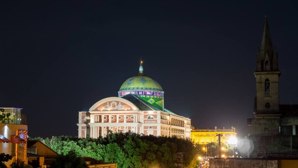A historic building with a large dome and a spire.