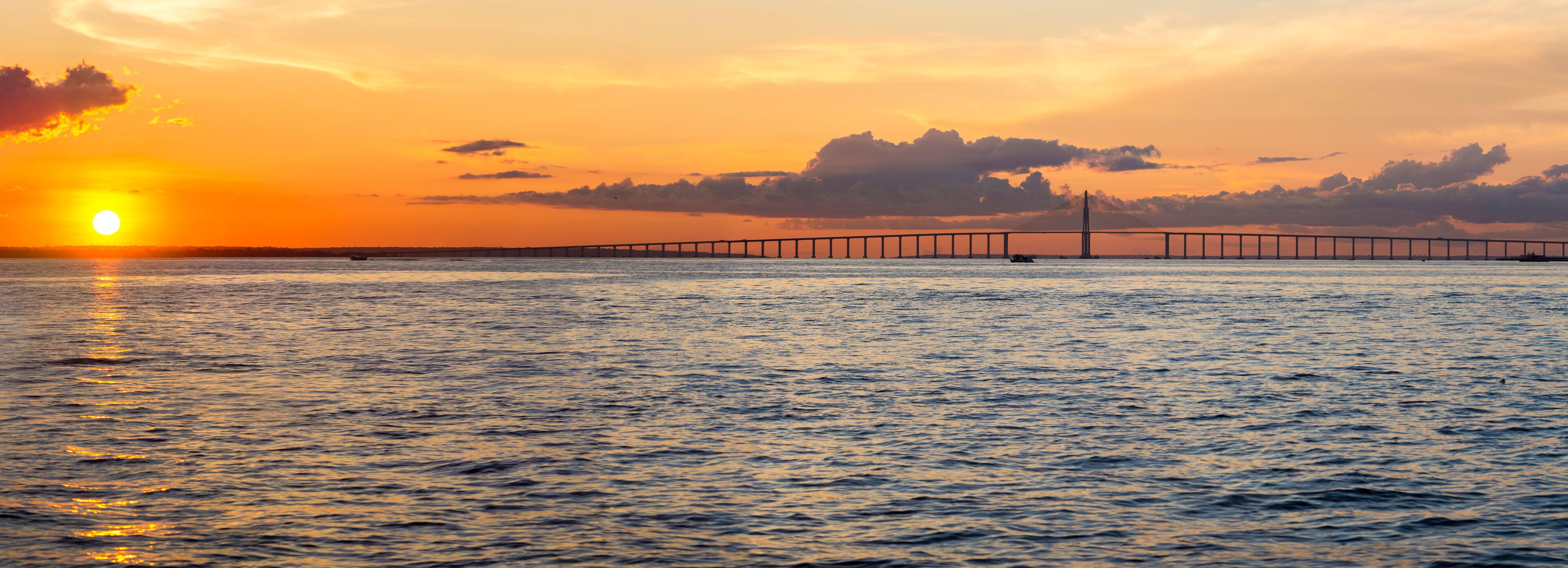 Sunset and Manaus Iranduba Bridge over the Amazon, Brazil