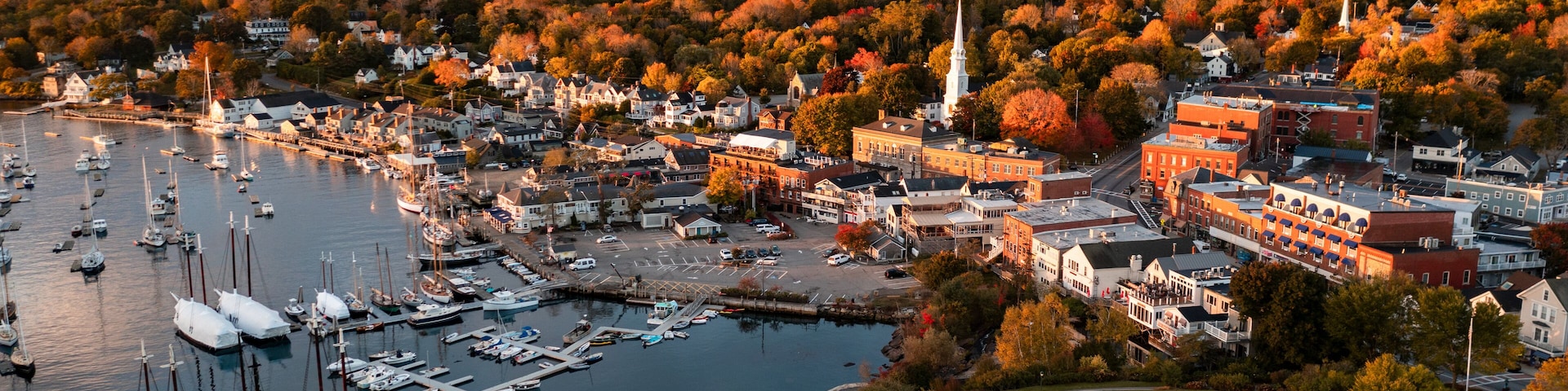 Panoramic view of sea harbor Camden, Maine town on east coast in New England, USA during sunrise in autumn season with fall foliage landscape