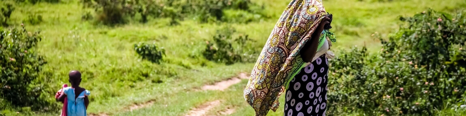 Whilst on a trip to Uganda visiting a rural community watching an NGo drilling for fresh water, I watched a lady beautifully dressed and her child walking along a road on their way home. 
_____________________
Mbarara ~ Uganada Africa