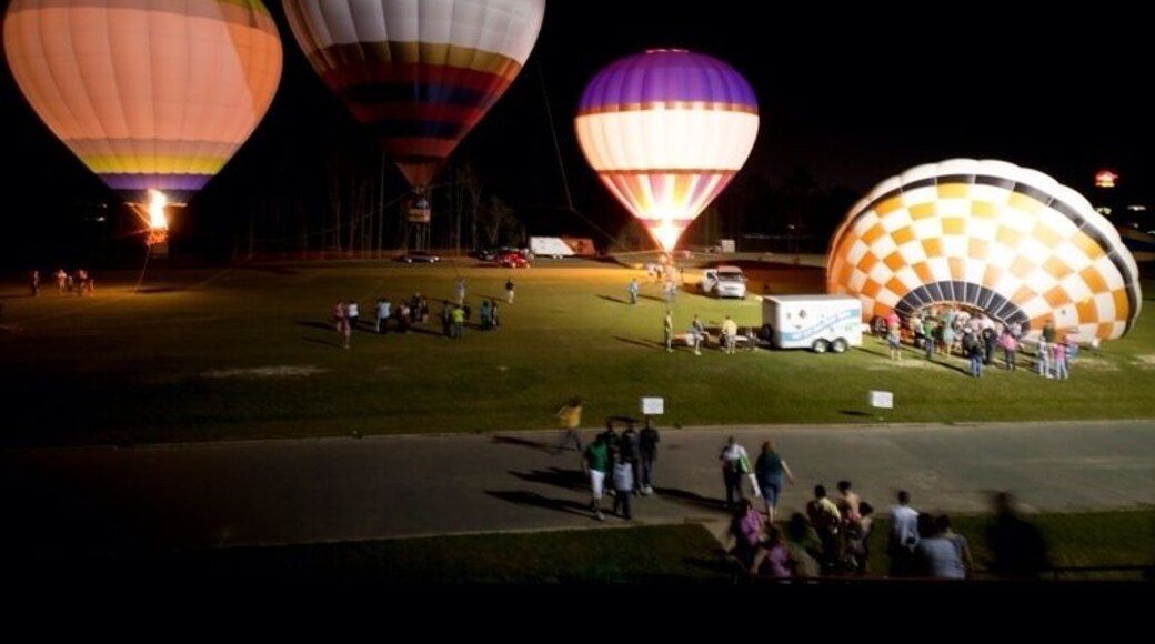 Each year in Macon, GA a festival bringing people in from surrounding area pops up for a week in early spring. The cherry blossom festival is a festival that most people have heard of, for I'm sure you have one near you. The one in Macon lasts a week an has carnival rides, strong man competitions, dog trick shows, mattress races, and many many more fun things to do all week.
On the first Saturday of the festival a unique event happens that brings tens of thousands to just sit and watch. The balloon glow. Hot air balloons come in from all around and set up in the fields outside Macon state college. During the afternoon and into the evening you are able to pay $10 and go up for a short ride that will briefly give you the experience of a hot air balloon ride. But at night, that is when things light up. With a live band on stage these balloons light up the night sky as they rise and fall through the air. With over 20 balloons it is beautiful when they all go off at the same time. People cheer, horns blow, bands play, and everyone has a great time as these balloons shows each year.