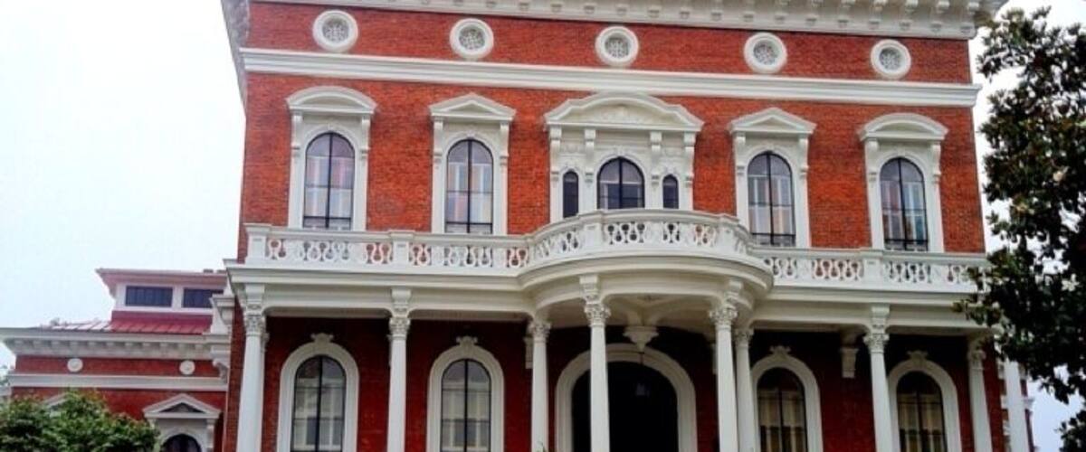 One of Georgia’s most distinguished structures, the Johnston-Felton-Hay House in Macon was declared a National Historic Landmark in 1974. It was built from 1855 to 1859 in the Italian Renaissance Revival style, a marked contrast to the more restrained Greek Revival architecture of the antebellum period.
The 18,000-square-foot mansion spans four levels and is crowned by a three-story cupola. Commissioned by imaginative owners and constructed by the most skillful workers of the time, its technological amenities were unsurpassed in the mid-19th century: hot and cold running water, central heat, a speaker-tube system, in-house kitchen and an elaborate ventilation system.
Only two families lived in Hay House over three generations. Most of the museum’s furnishings date from the Hay family’s occupancy (1926-1962). A few pieces are from the Johnston family (1860-1896), most notably the Eastlake-style dining room suite. The most important piece in the collection may be the 1857 marble statue, "Ruth Gleaning," by American expatriate sculptor Randolph Rogers.
The Johnstons
William Butler Johnston was no typical nineteenth-century Southerner. He obtained his substantial wealth through investments in banking, railroads and public utilities rather than from the agrarian cotton economy. In 1851, he married Anne Clark Tracy, 20 years his junior, and the two embarked on an extended honeymoon in Europe. During their trip, the Johnston's visited hundreds of museums, historic sites and art studios. They collected fine porcelains, sculptures and paintings as mementos of their Grand Tour. The Johnston's were inspired by the Italian architecture they observed and, upon their return to America, constructed a monumental Italian Renaissance Revival mansion in Macon.
The Feltons
Completed in 1859 and called the "Palace of the South," the residence was decorated and furnished in accordance with wealth and good taste. It became a beloved home for the Johnston's, their daughters and their extended family. After the death of Mrs. Johnston in 1896, daughter Mary Ellen and her husband William H. Felton lived in the house. They remodeled and redecorated parts of the house, updated the plumbing and added electricity.
The Hays
After the deaths of Judge and Ms. Felton in 1926, Felton heirs sold the house to Parks Lee Hay, founder of the Banker's Health & Life Insurance Company. The Hays substantially redecorated the house to reflect the changing character of twentieth-century living, and the house at 934 Georgia Avenue continued to be recognized as a local landmark for gracious living during the Hay ownership.
After Mrs. Hay's death in 1962, her heirs established the P.L. Hay Foundation and operated the house as a private house museum. In 1977, ownership of the house was formally transferred to the Georgia Trust for Historic Preservation. The house has been operated by the Trust since that time and has been designated as a National Historic Landmark.