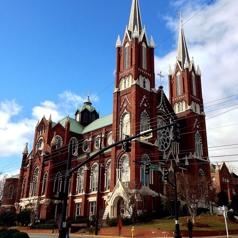 The history of Roman Catholicism in Macon dates to a visit in 1829 by Bishop John England of the Diocese of Charleston and the subsequent migration of Irish Catholic families in the 1830s. In 1841, Macon's Catholics received their first pastor, Father James Graham. A succession of buildings and sites was purchased and used by Macon's Catholics during the nineteenth century, until the construction of St. Joseph's Catholic Church at this location from 1889-1903. This Gothic Revival structure, designed by Brother Cornelius Otten, features a domed cupola, flying buttresses, stained-glass windows from Bavaria, and a high altar of Carrara marble.