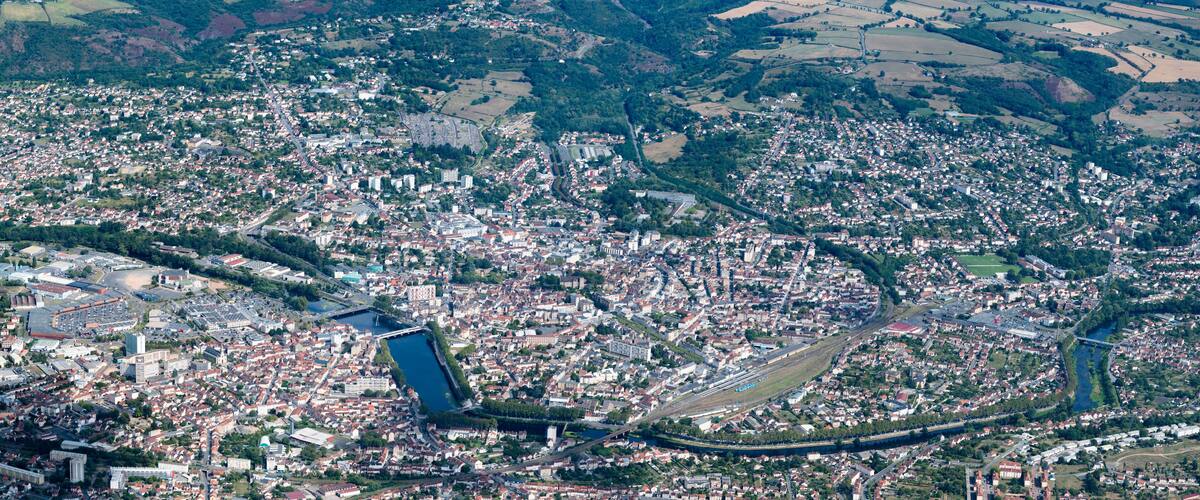 An aerial view of a densely populated city with a prominent river running through it.