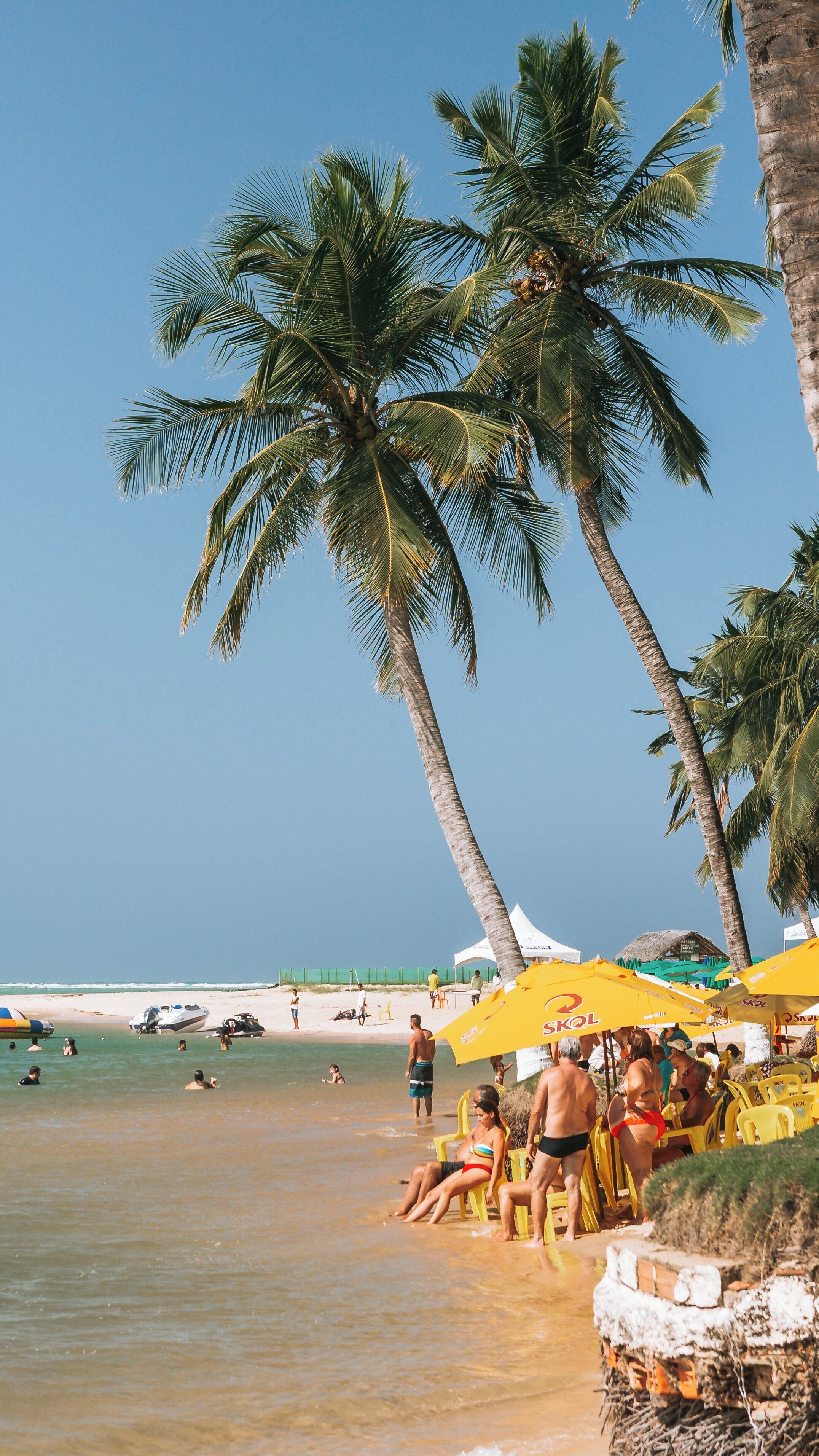 Relaxing day at Gunga Beach in Maceio, Alagoas, Brazil with vibrant umbrellas and clear waters