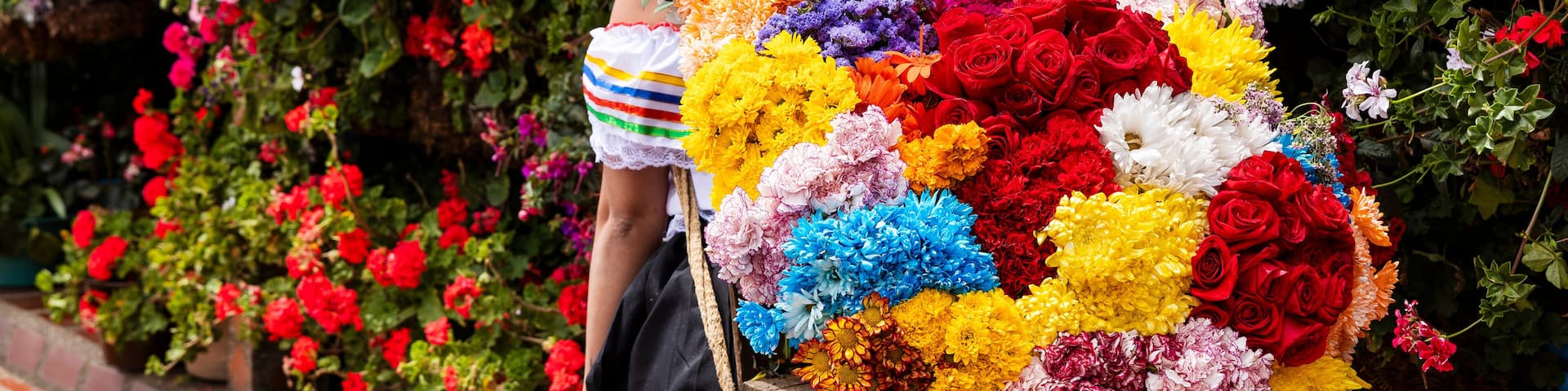 A person carrying a large bouquet of flowers.