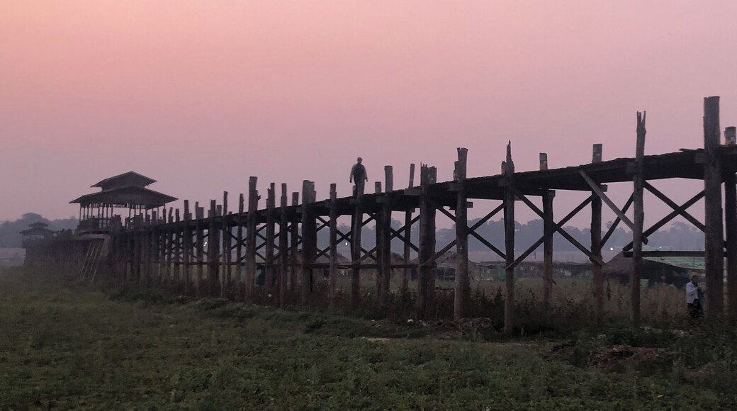 Sunrise on U Bein Bridge. If you get off the night bus from Inle Lake you can get a tuk tuk to the bridge and watch the sun go up as the monks walk to and from on their daily activity.