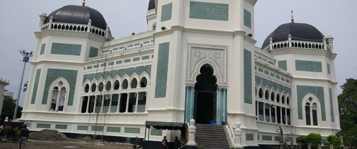 The mosque is currently being renovated but is still open to the public. It was built by the Dutch & contains marble from Italy; a Chandelier from France; & stained glass from Spain.