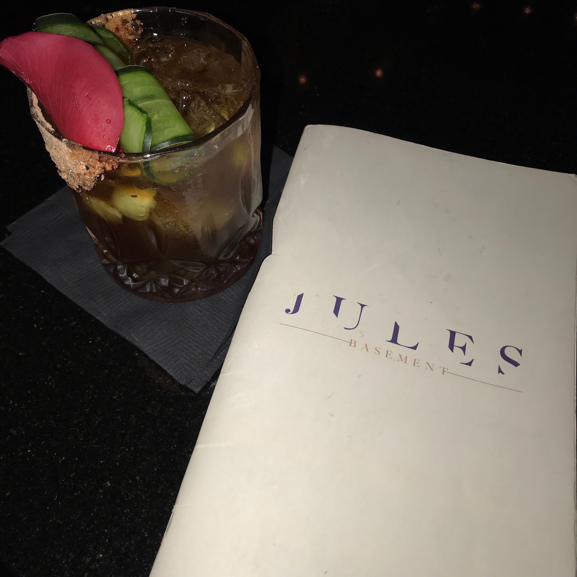 Look for the bright covered table cloths, then find the refrigerator door, then head downstairs to the basement for wonderful craft cocktails. 