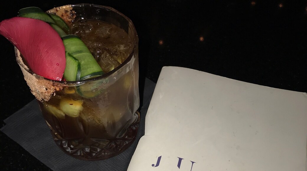 Look for the bright covered table cloths, then find the refrigerator door, then head downstairs to the basement for wonderful craft cocktails.