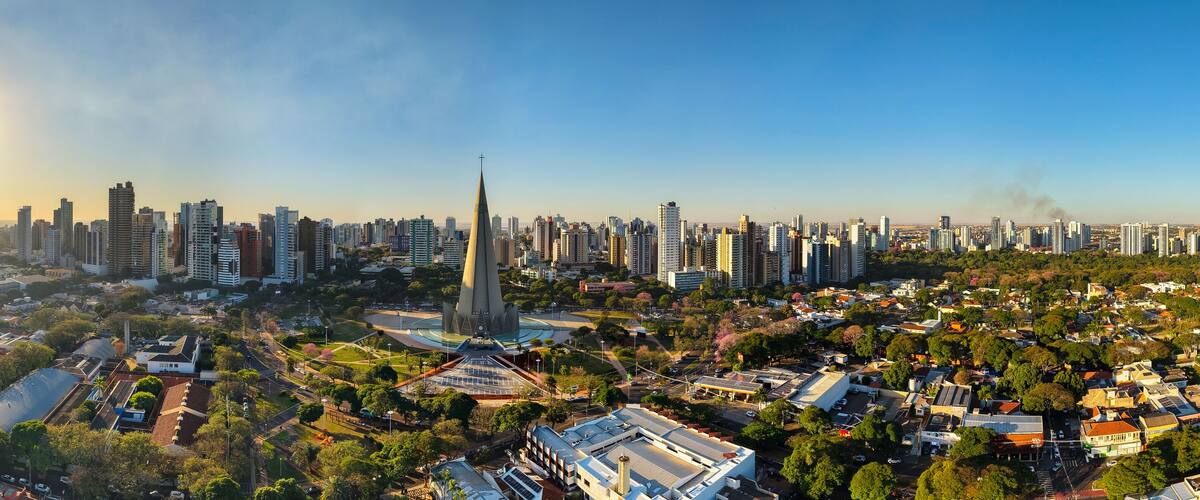 A cityscape with a prominent church steeple, dense high-rise buildings, and a mix of residential and commercial areas.