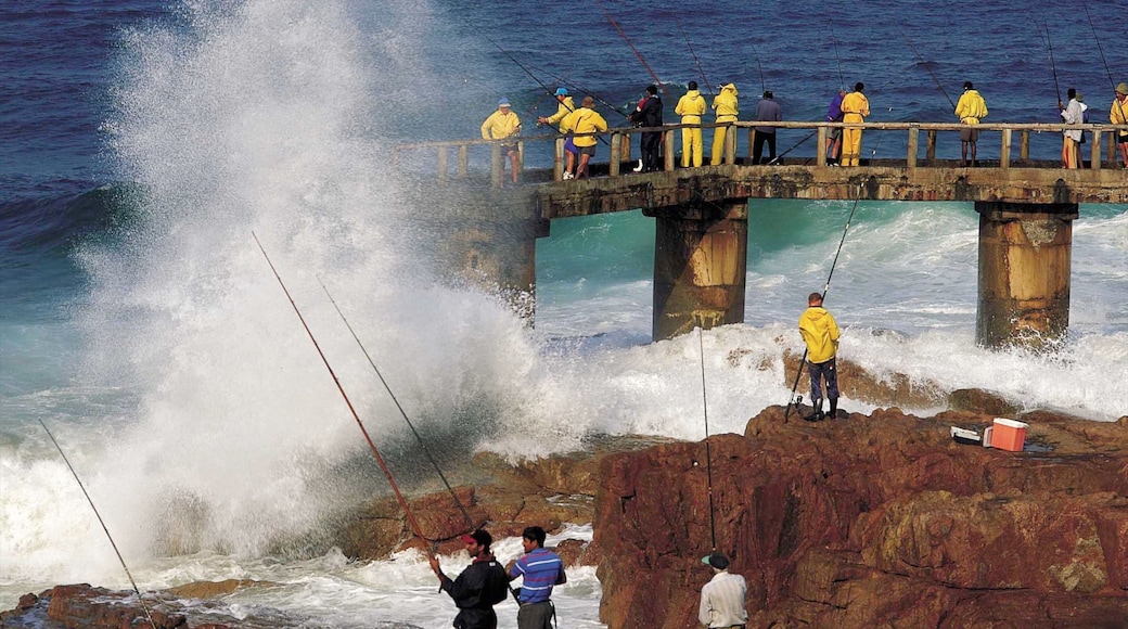 Margate which includes rocky coastline and fishing as well as a large group of people