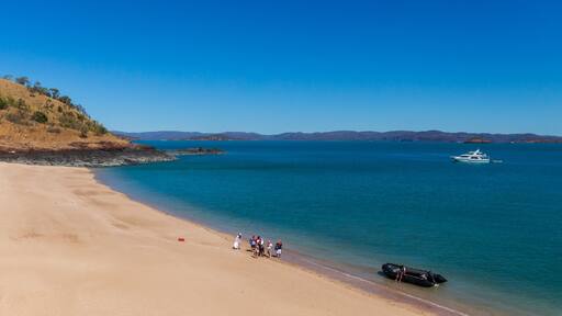 Tourists from a luxury expedition cruise ship explore a remote beach on Naturalist Island in the Kimberley before a sightseeing flight over Prince Frederick Harbour.