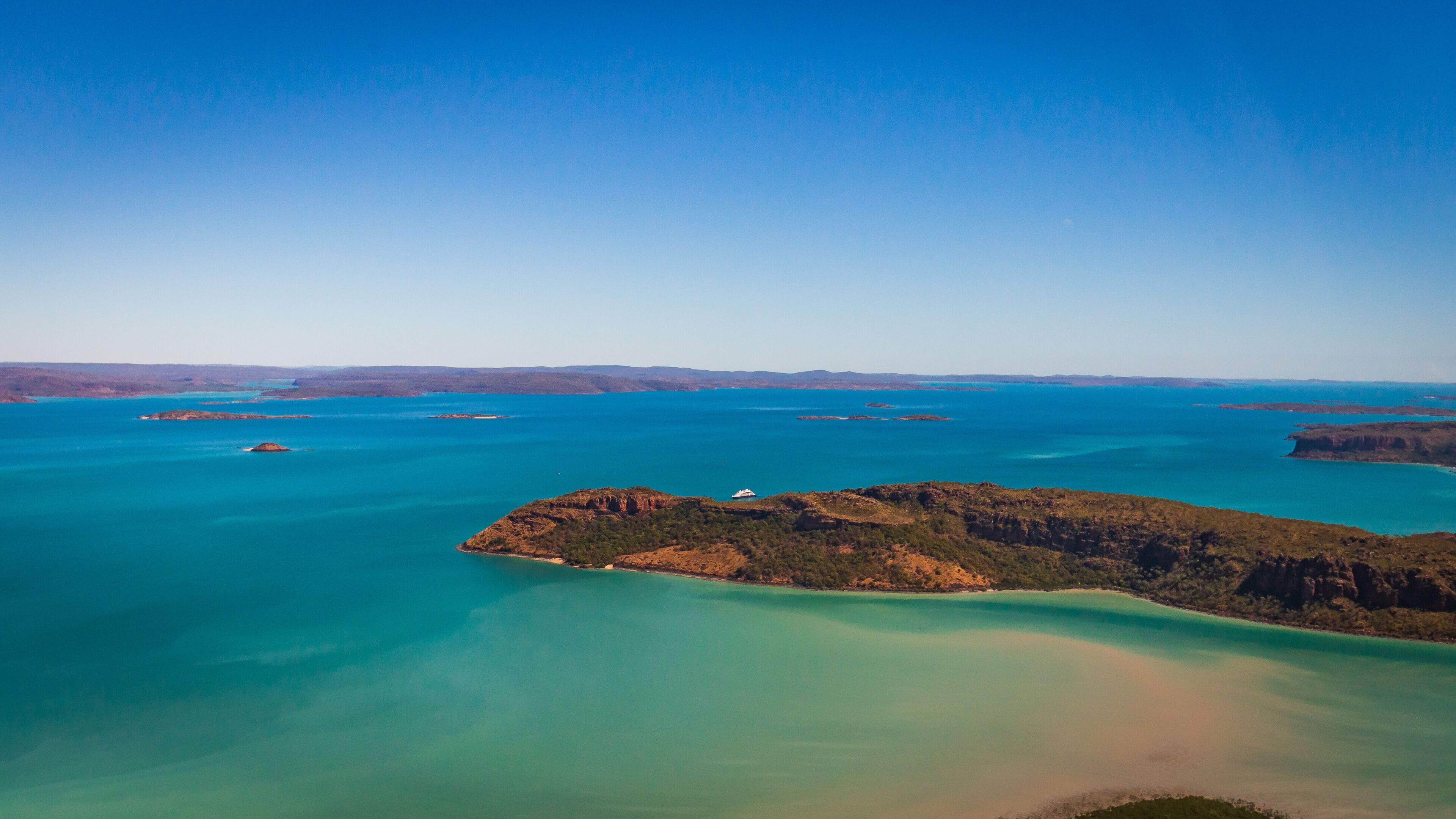 Landscape aerial view of Naturalist Island in Prince Frederick Harbor, North Kimberley. Frequenctly visited by cruise ships, a beach serves as a helicopter landing pad for sightseeing flights