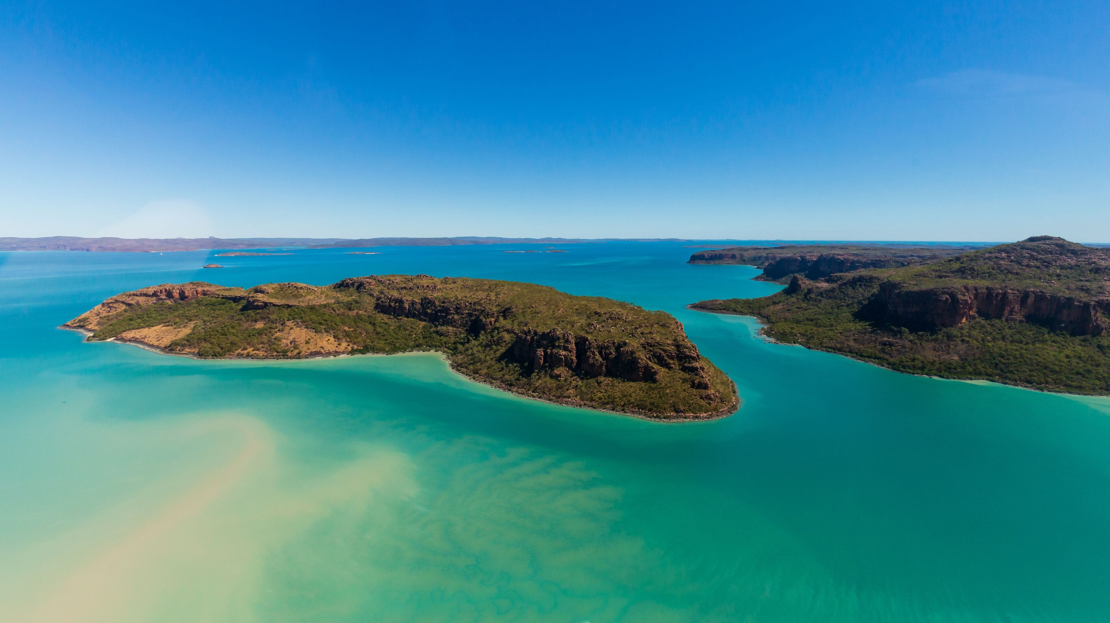 Landscape aerial view of Naturalist Island in Prince Frederick Harbor, North Kimberley. Frequenctly visited by cruise ships, a beach serves as a helicopter landing pad for sightseeing flights