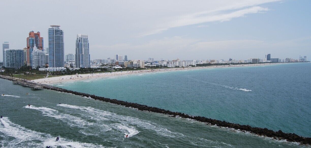 This is a shot of Miami Port as we are leaving on a Cruise Ship to go to The Caribean. When we leave this port,  the captain of the cruise line follows in a captain's boat while the ports captain takes the ship out of port. Right about now the smaller boat  is comming up to the Cruise ship to switch captains.
