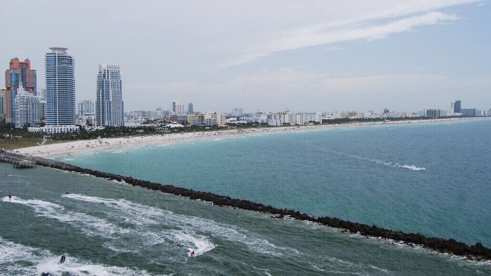 This is a shot of Miami Port as we are leaving on a Cruise Ship to go to The Caribean. When we leave this port, the captain of the cruise line follows in a captain's boat while the ports captain takes the ship out of port. Right about now the smaller boat is comming up to the Cruise ship to switch captains.