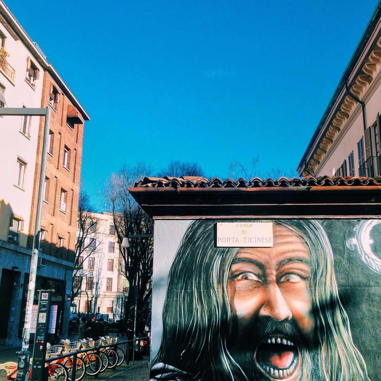 A street mural with a sign reading "CORSO DI PORTA TICHESE".