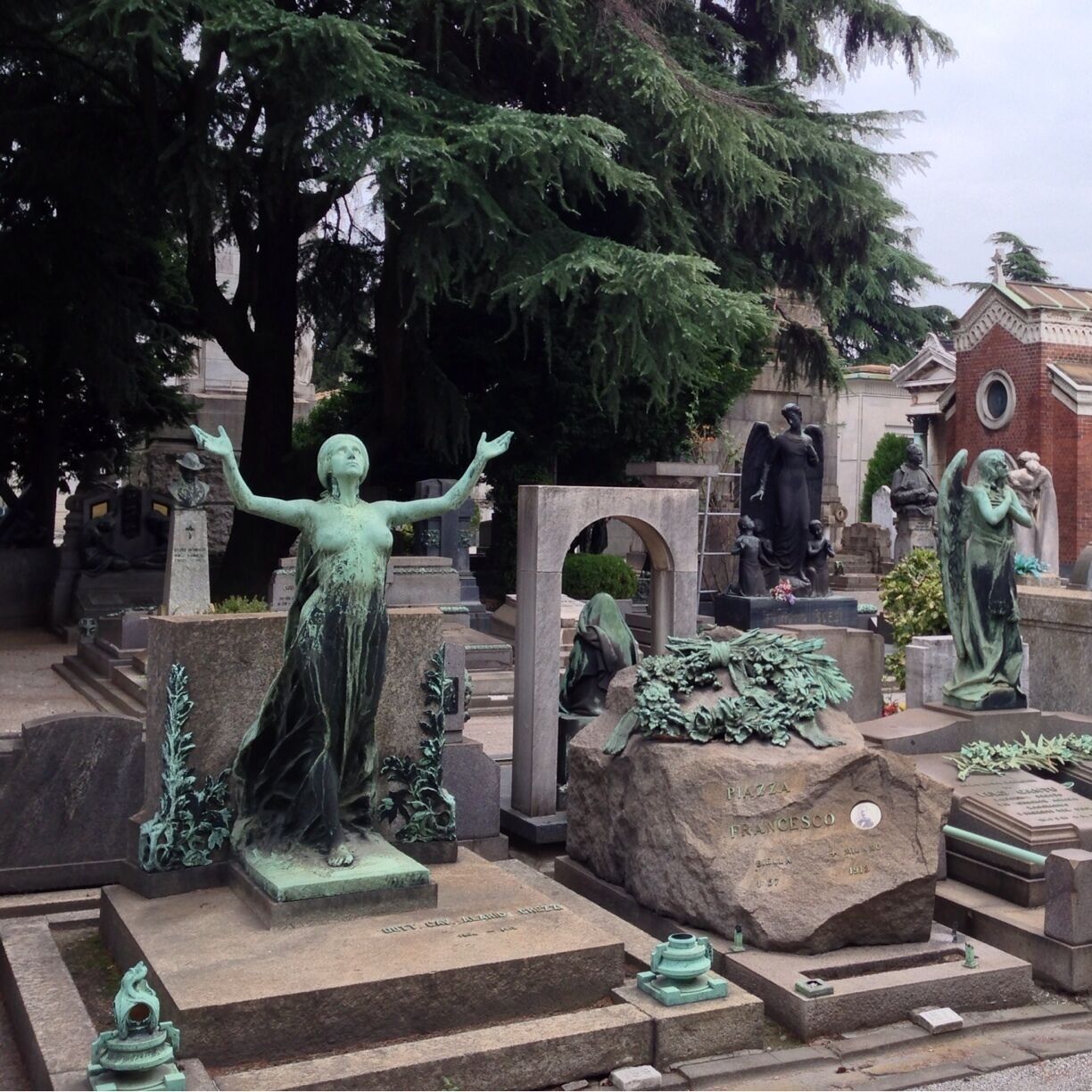 Quite amazing to see this cemetery. Milan's wealthy families seemed to try and top each other by building large tombs often decorated with plenty of sculptures of angels, putti, sphinx or other figures. All kind of architectural styles were used, from Egyptian, neo-Roman and Byzantine over neo-Gothic to more modern styles such as Art Nouveau, modernist and even post-modern. 

The sheer number of different works of art by often highly acclaimed artists resulted in an interesting open air museum, where visitors are easily overwhelmed by the large number of monumental mausoleums and sculptures. Fortunately placards installed on the grounds of the cemetery that show an overview of the most spectacular and most famous graves. 