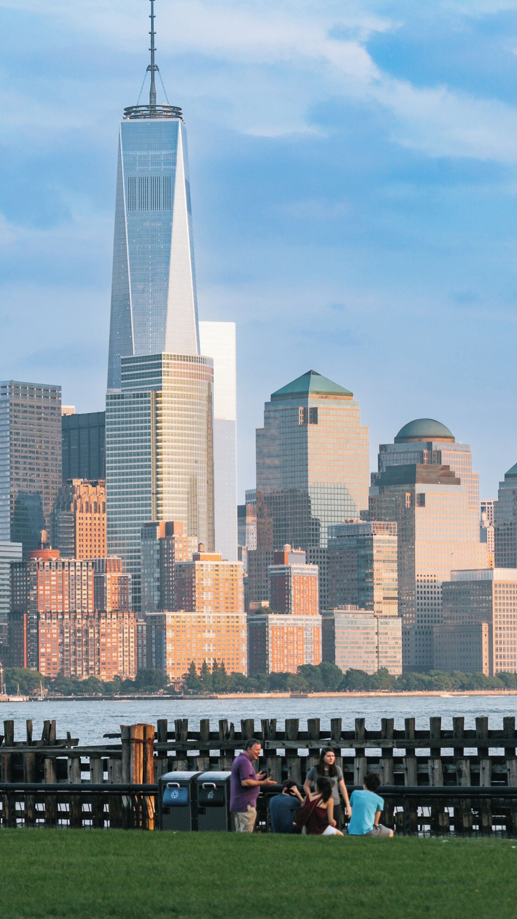 Enjoying leisure time at Hoboken Waterfront with stunning views of the Manhattan skyline in Hoboken, New Jersey during a sunny afternoon