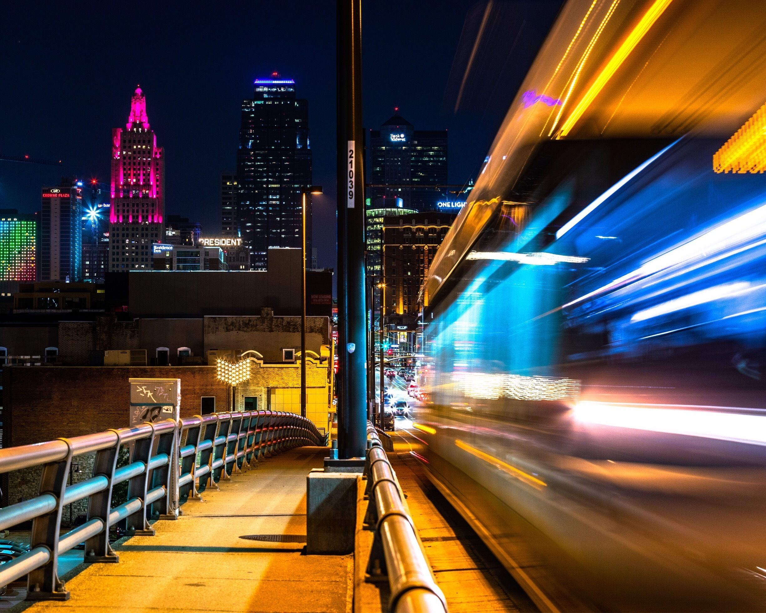 There is an overpass that has a great view of the city and there metro/rail system has a car that runs on the overpass. Under the overpass are a set of four or five train tracks for other cool shots. Great spot for sunset and night shots. If you get dropped off at the Jack Stack restaurant and walk around toward the far end of the parking lot, past the other restaurants there, you will find a set of stairs to bring you to the overpass. 