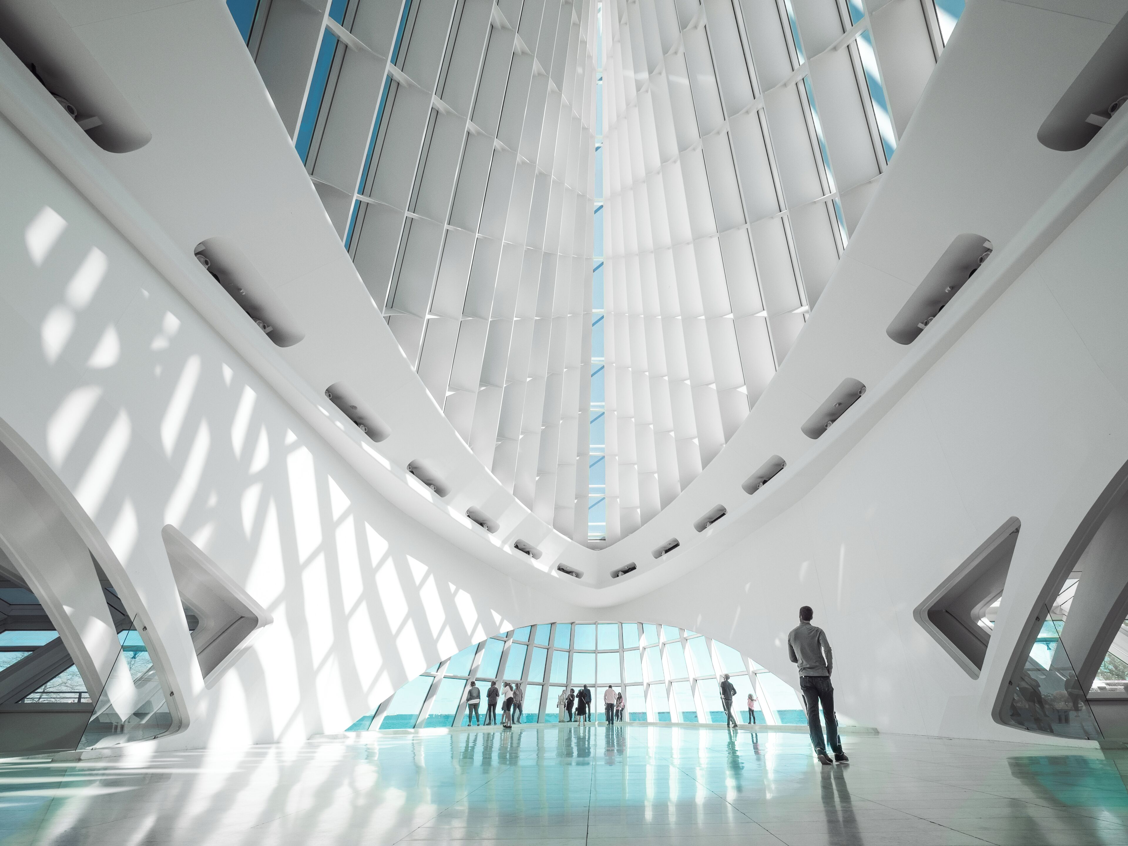 Inside the Milwaukee Art Museum is the magnificent cathedral-like space of Windhover Hall, with a vaulted a 90-foot-high glass ceiling that overlooks the harbor entrance and Lake Michigan. Awash in white with marble flooring, this open area serves as the gateway to the Museum.

#milwaukee #wisconsin #museum #architecture #perspective 