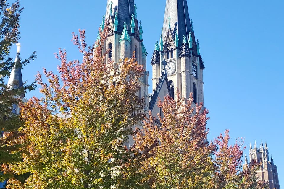 A church with two tall spires and a clock tower.
