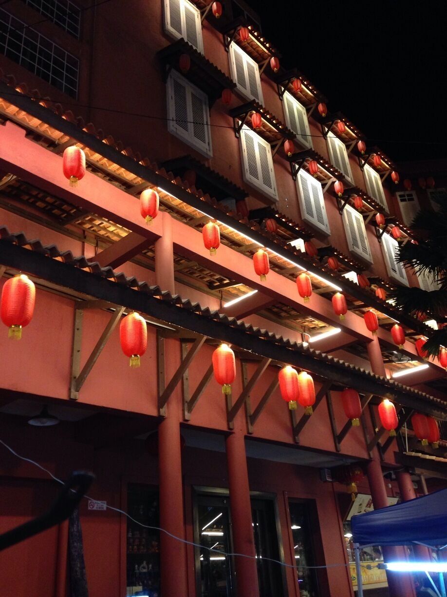 A traditional building with red lanterns and wooden beams.
