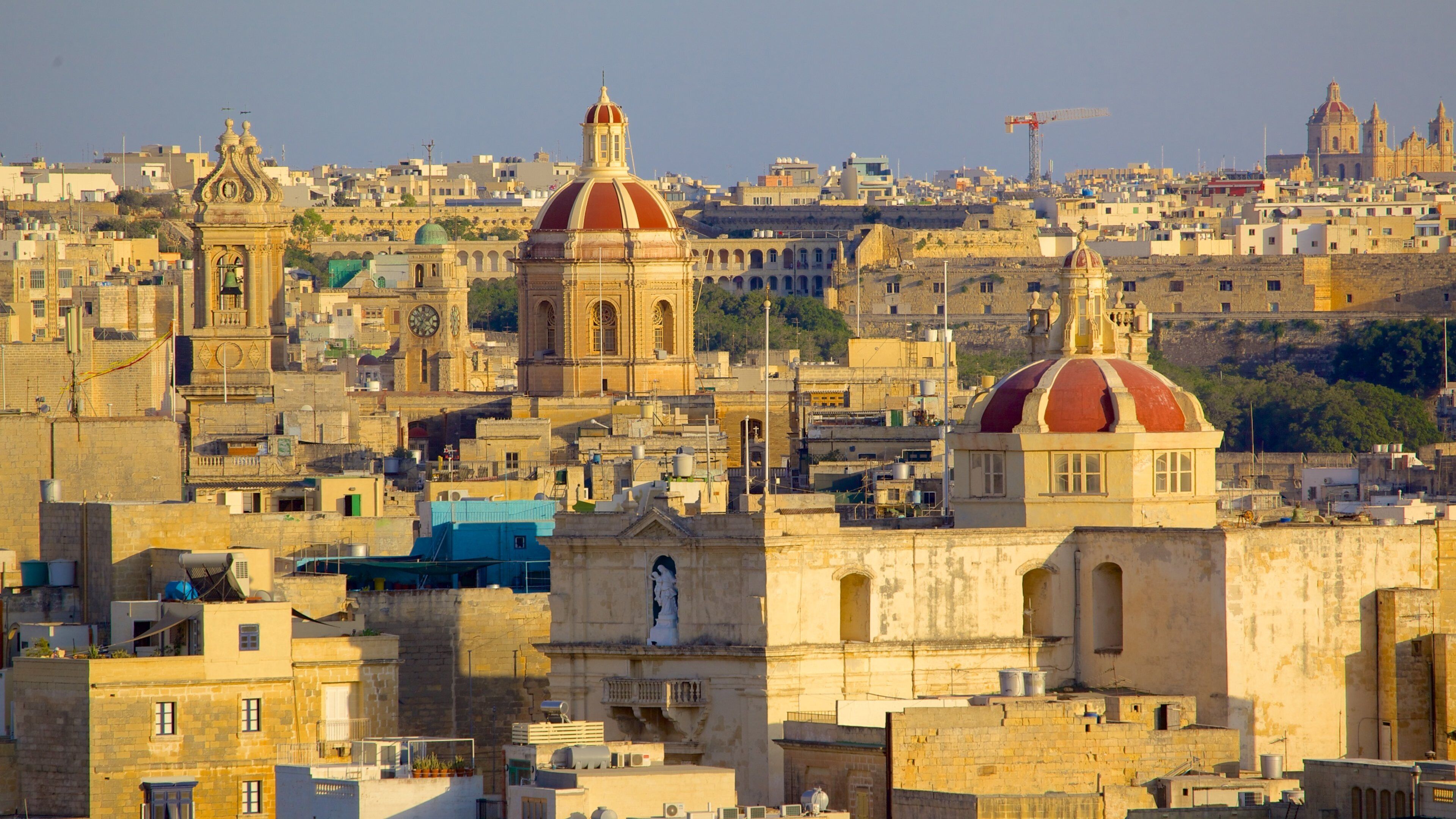 A cityscape with prominent domed buildings and a historic church.
