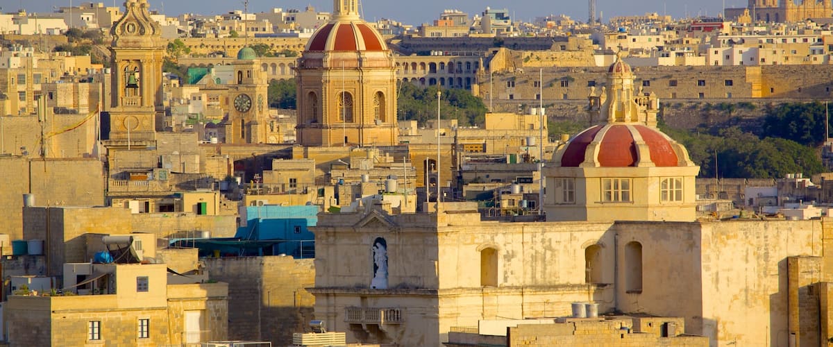 A cityscape with prominent domed buildings and a historic church.