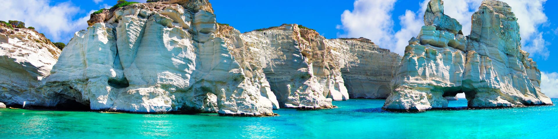 Crystal clear sea of Greek islands. Milos, boat trip in Kleftiko bay. Cyclades