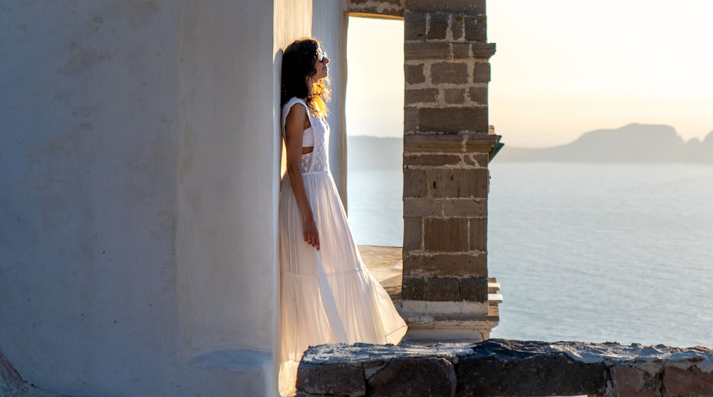Woman in white dress looking at the sea in Plaka, MIlos