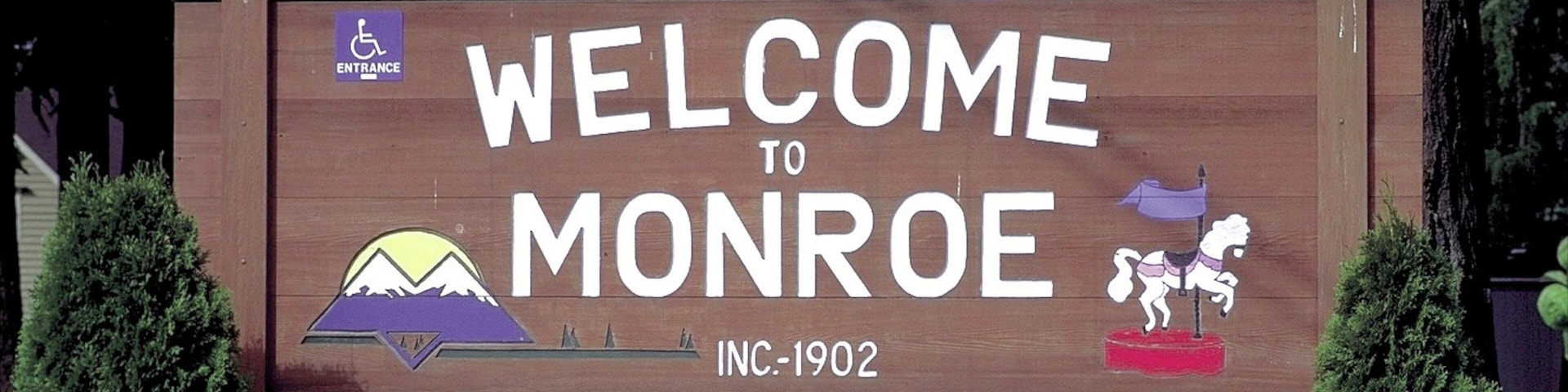 Monroe which includes signage and flowers
