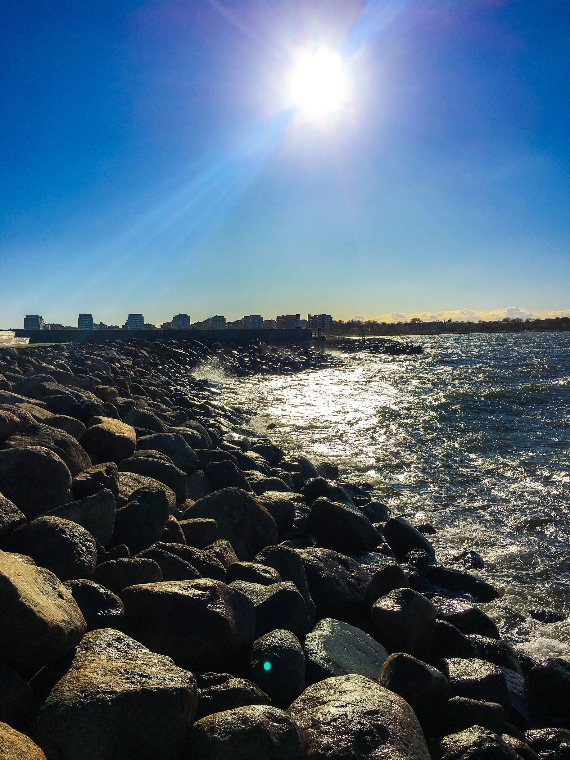Rocky beaches, clear blue sky, yet ice cold and stormy #malmö #coast #beach