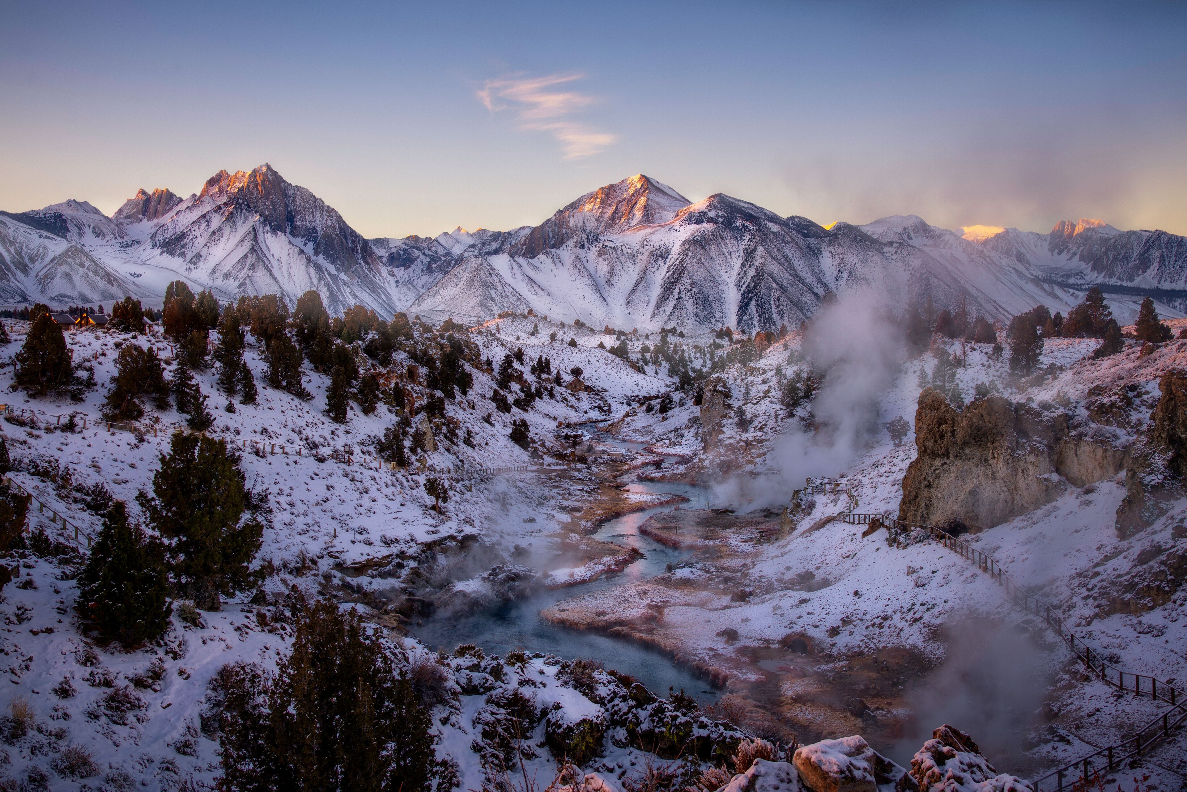 A snow-covered mountain range with a river flowing through a valley.