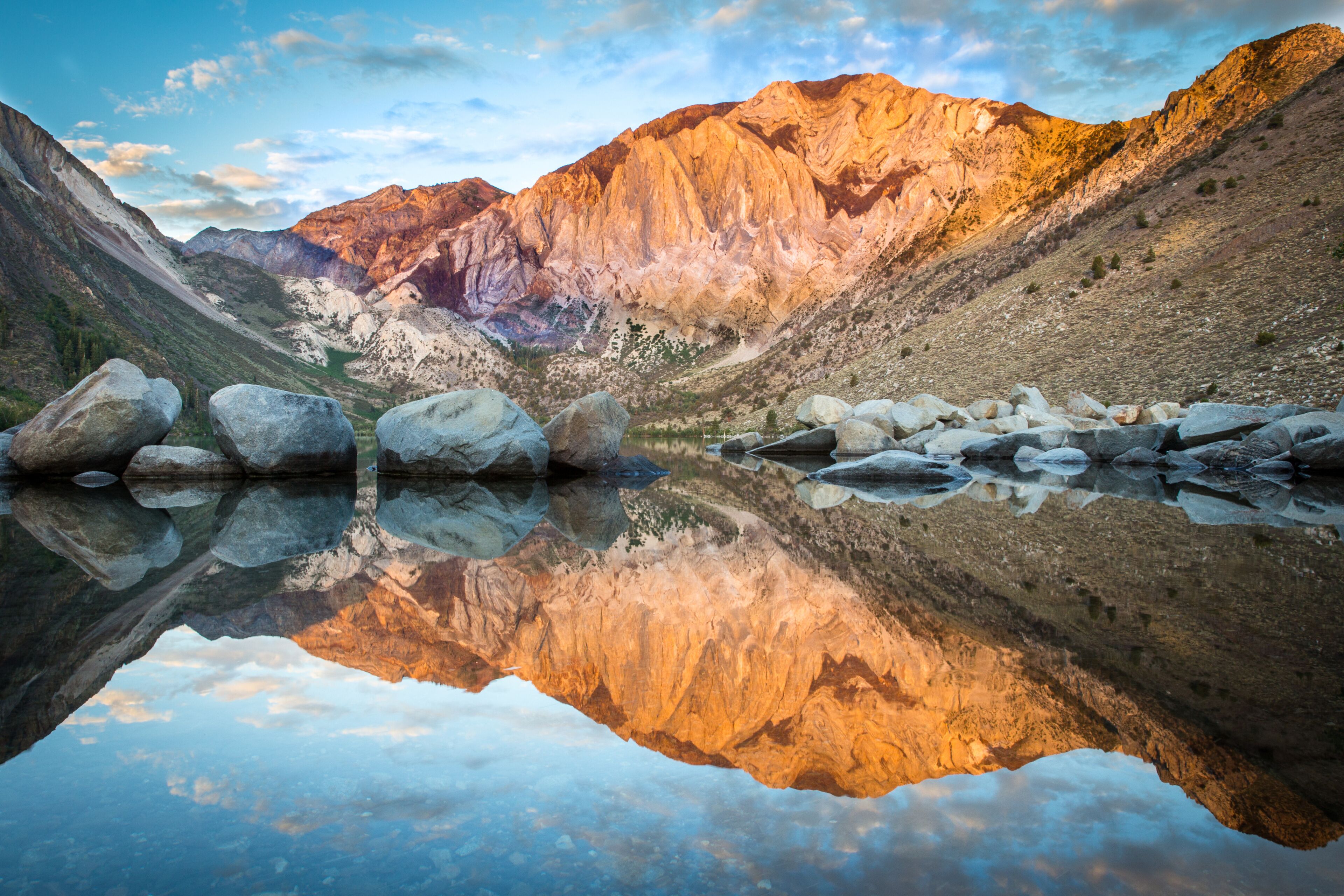 A mountain landscape with a clear lake reflecting the mountains.