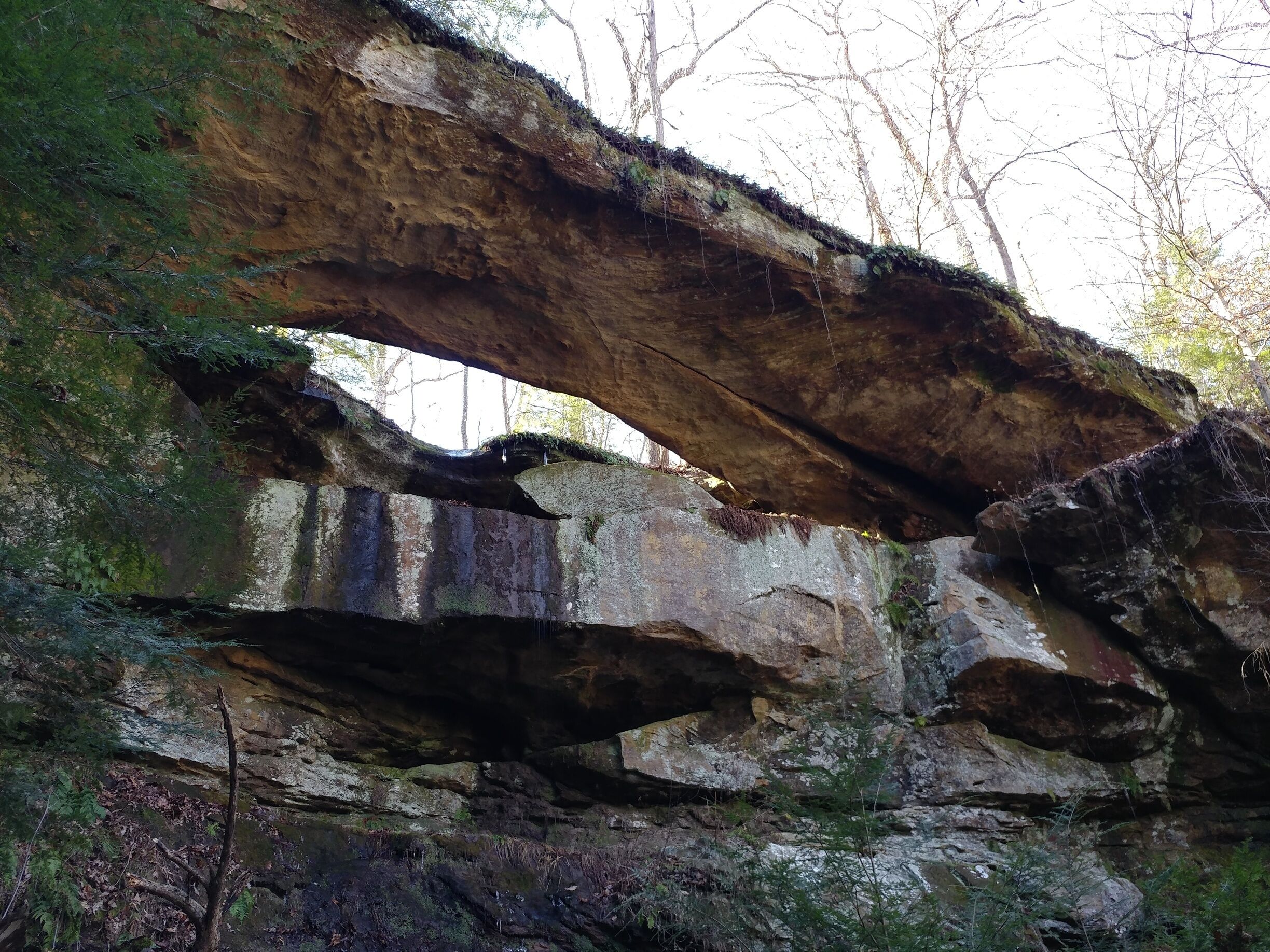 A natural rock formation with a large overhang.