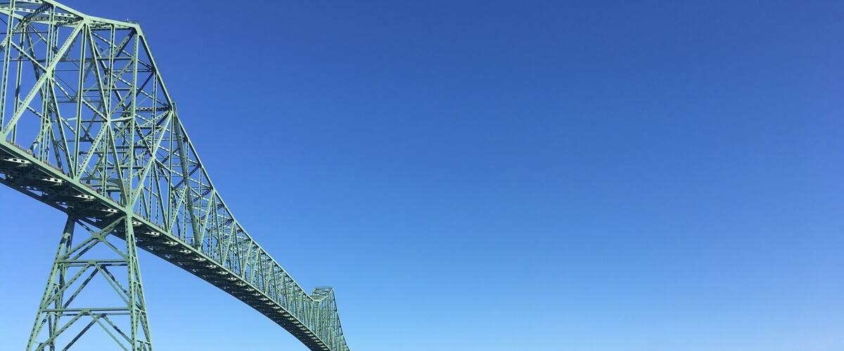 A rare sunny morning in Astoria as the fog rolls off the Colombia River. The Astoria Megler Bridge is the longest continuous truss bridge in North America. The best view of the bridge from a low angle shot is on the boardwalk to the right of the Holiday Inn.