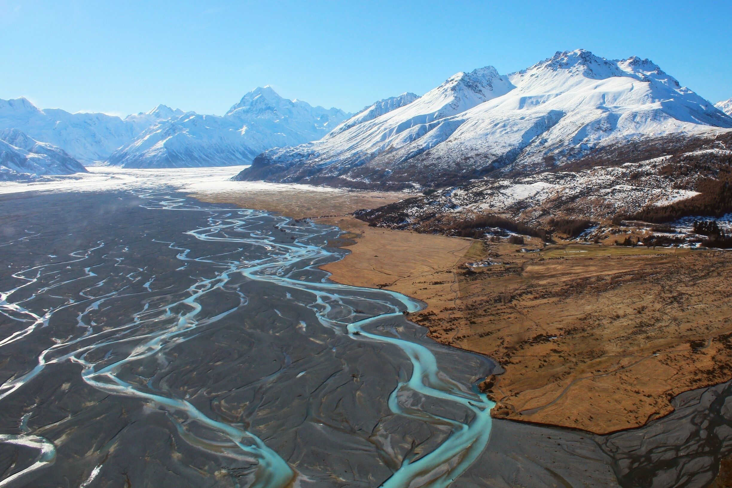 Flying over the braided rivers feeding into Lake Pukaki, getting an unreal perspective of Mount Cook and the snow covered village below with The Helicopter Line  🚁