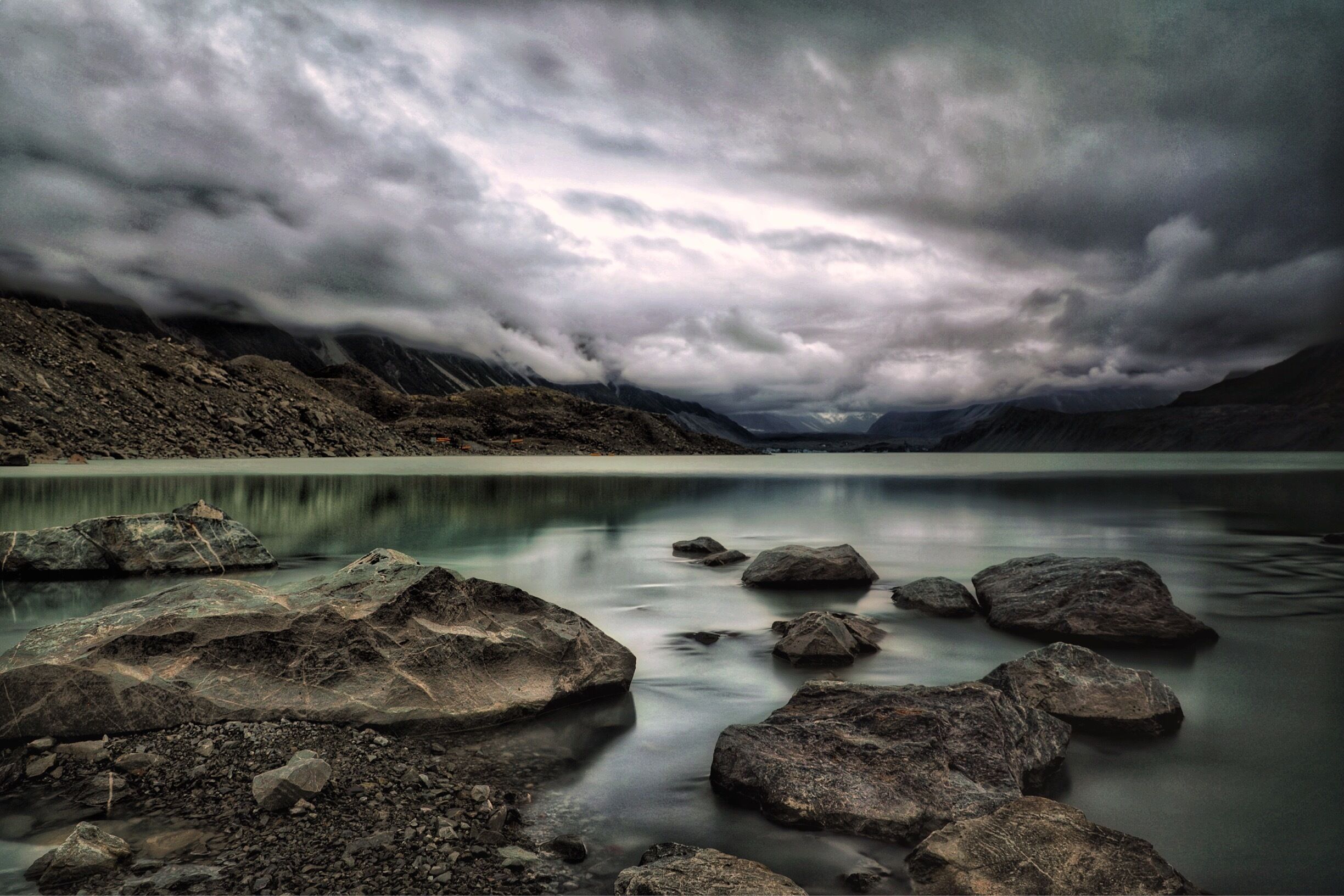 With the weather being closed in for most of the day, our planned destination was revised and here we were.  A 30 minute leisurely walk through Alpine paths, a scramble down the rocks and this is what you could be met with.  Icebergs still floating in Spring (not that the weather felt like Spring), moody skies and in the distance the glacial ice.  This area, not that long ago was more glacial than lake.  Yes, it was once Tasman Glacier.  You could stay here for hours, I did.  #newzealand #glacier #lake #nature