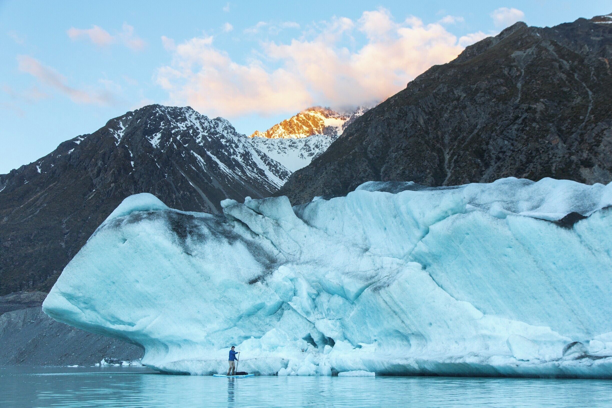 In this photo you see us paddle boarding next to an iceberg. This is in Tasman glacier lake in New Zealand. It's a 4 hour drive from queenstown and a 3 hour drive from Christchurch
 #BvSApplication.