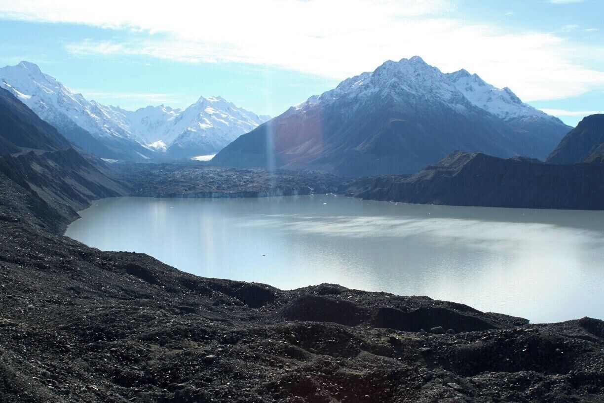 From the glacier view point you look out over the glacier lake. The black stuff in the background is the actual glacier. Pretty ugly with all that dirt.
