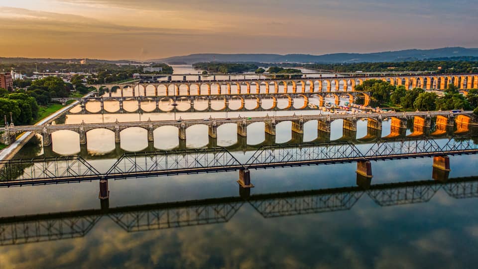 A large dam with multiple gates and a bridge crossing over a river.